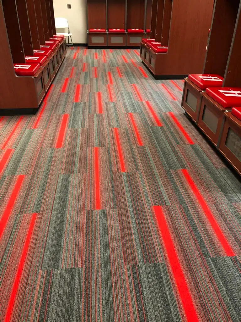 red and gray flooring in the Huntingdon College Baseball locker room installed by Weiss Commercial Flooring